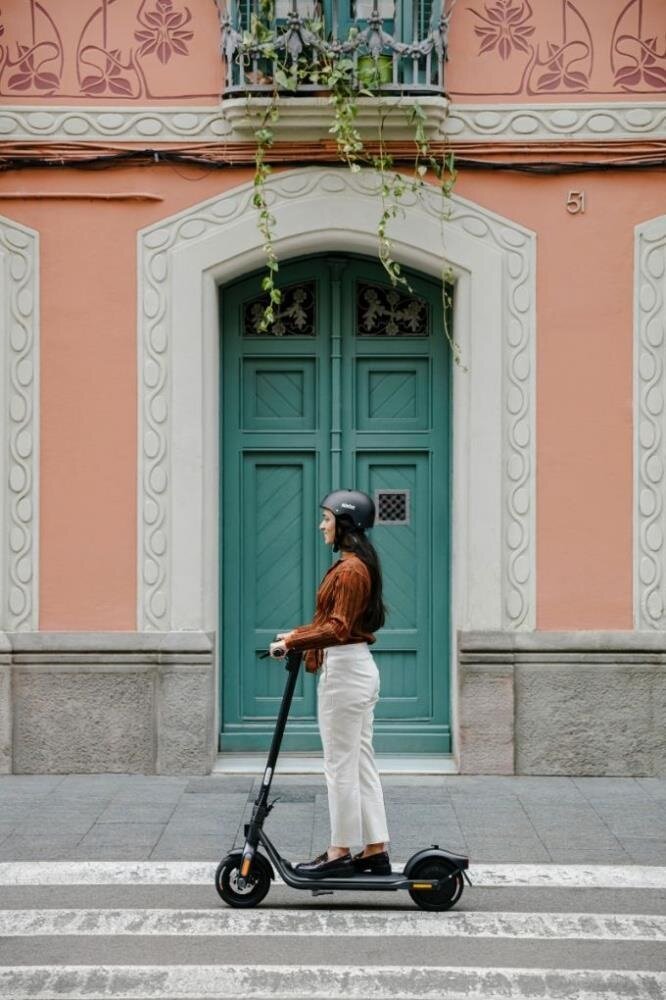 Hulajnoga elektryczna Segway Ninebot KickScooter F2 D 10” kobieta jadąca na hulajnodze