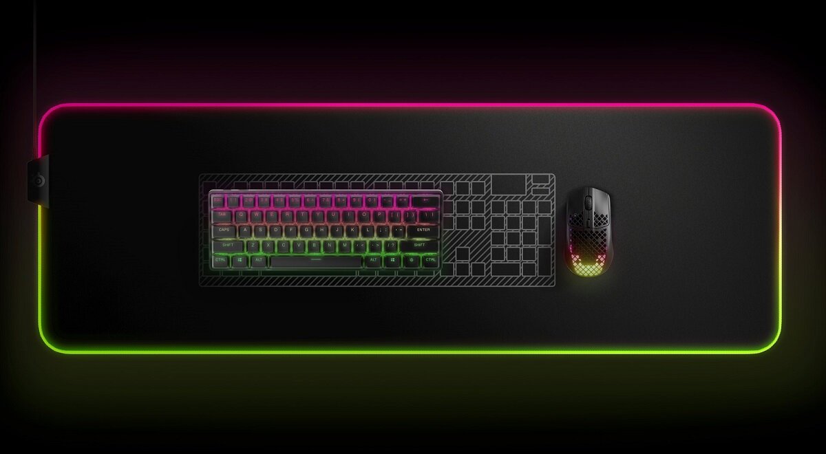 Klawiatura SteelSeries Apex Pro Mini Wireless US na stole na czarnym tle z włączonym RGB