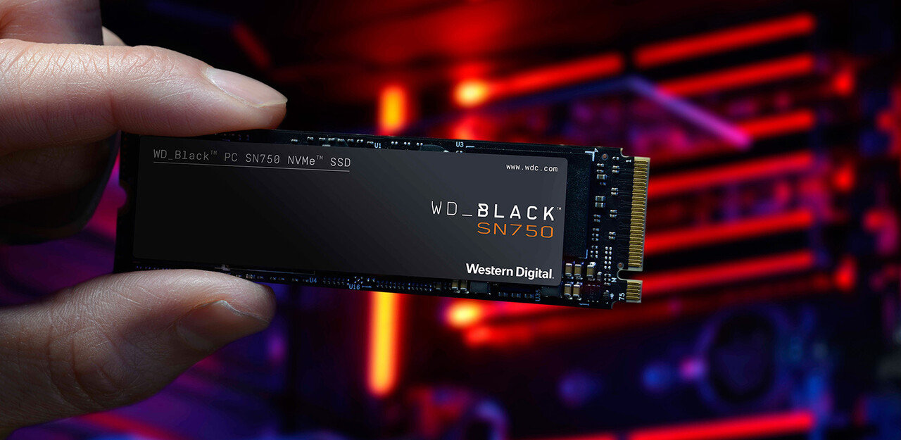 Dysk SSD WD 2TB M.2 PCIe NVMe Black SN750 WDS200T3XHC dysk między palcami człowieka 