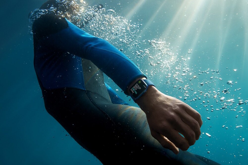 Smartwatch Apple Watch Series 7 GPS + Cellular MKHU3WB/A widok na mężczyznę pod wodą z zegarkiem na nadgarstku