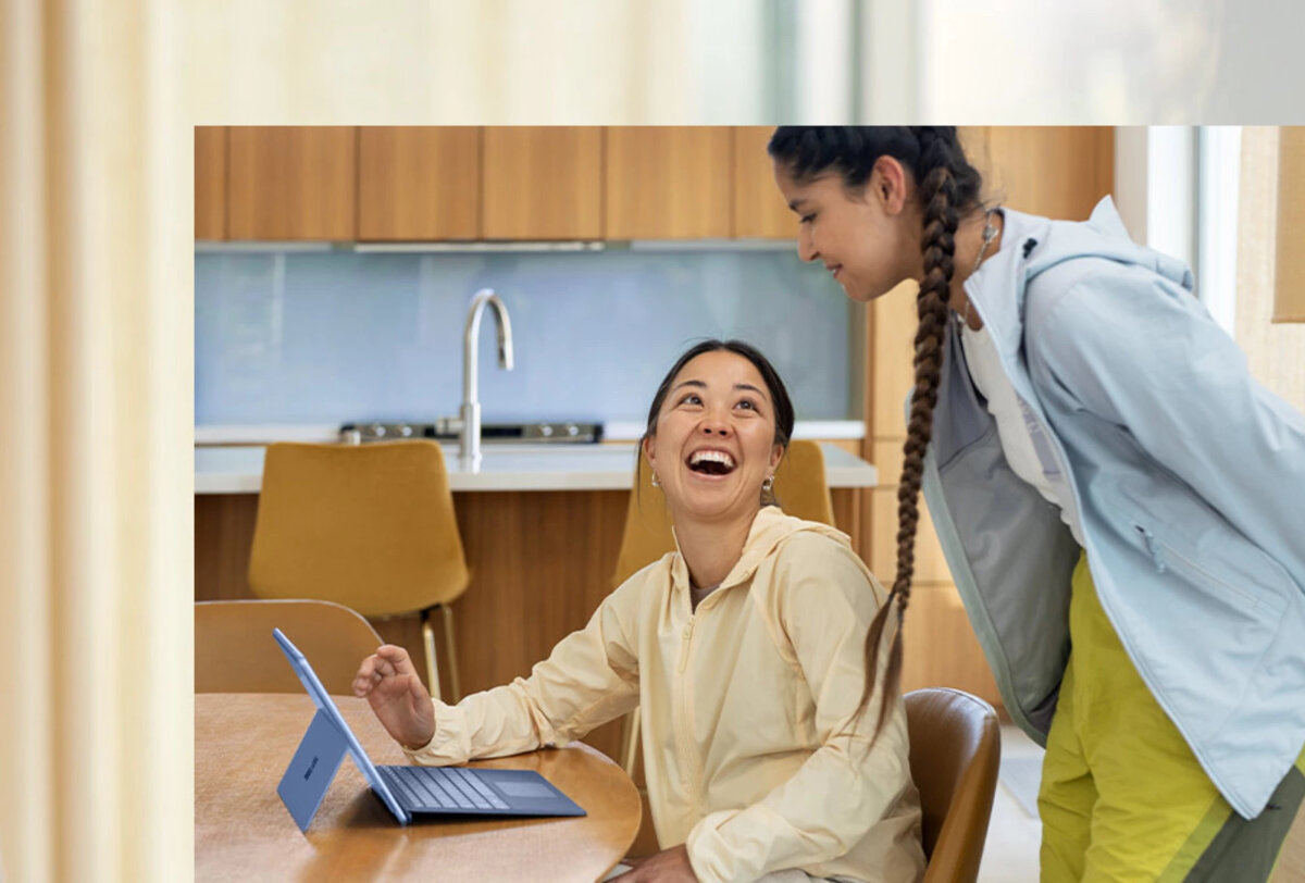 Laptop Microsoft Surface Pro 9 16GB/1TB grafika przedstawiająca kobiete siedzącą przed tabletem, obok stoi druga kobieta, w tle szafki kuchenne
