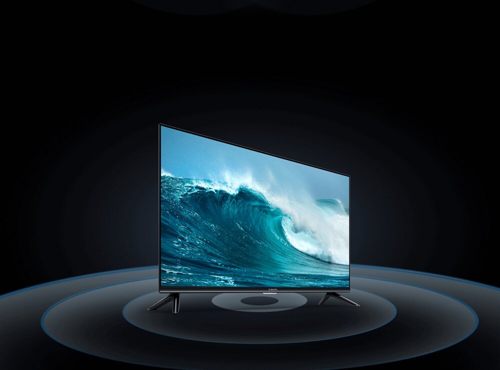 Telewizor Xiaomi Mi LED TV A2 pod skosem w prawo z grafiką wizualizującą rozchodzenie się dźwięku z głośników