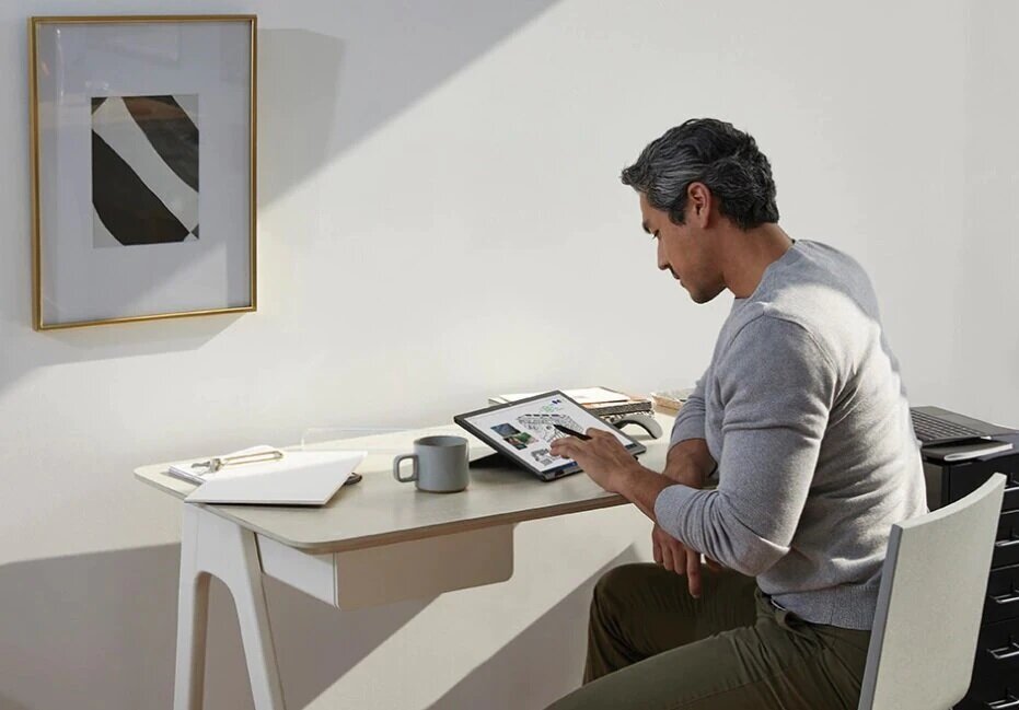 Laptop Microsoft Surface Go z mężczyzną przy biurku