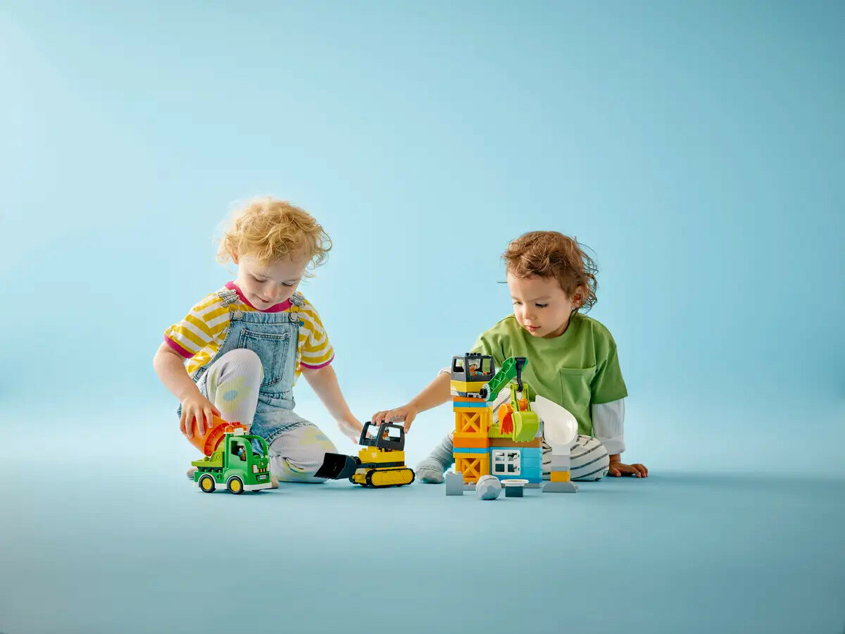 Klocki Lego Duplo Budowa 10990 dwójka dzieci bawiąca się zestawem klocków w pozycji siedzącej