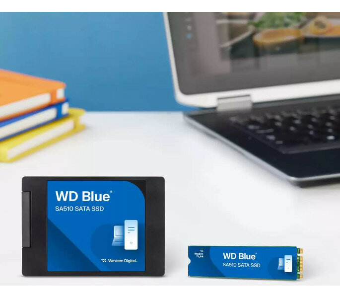 Dysk SSD Western Digital Blue SA510 SATA zdjęcie dysku na biurku z laptopem w tle