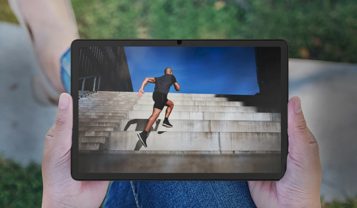 Folia ochronna Samsung Anti-Reflecting Screen Protector do Tab S9 antyrefleksyjna tablet trzymany w dłoniach a na ekranie wbiegający po schodach mężczyzna