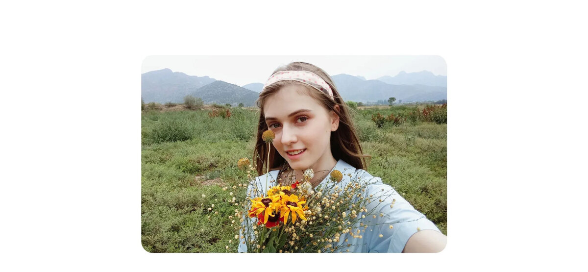Smartfon Xiaomi Redmi 9A 2/32GB szary dziewczyna z kwiatami na tle zieleni oraz gór