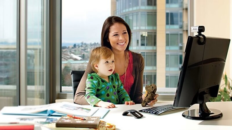 Kamera internetowa Microsoft LifeCam Studio 5WH-00002 srebrna z kobietą w biurze podczas rozmowy wideo